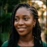 Amaka smiling outdoors in Lagos at golden hour